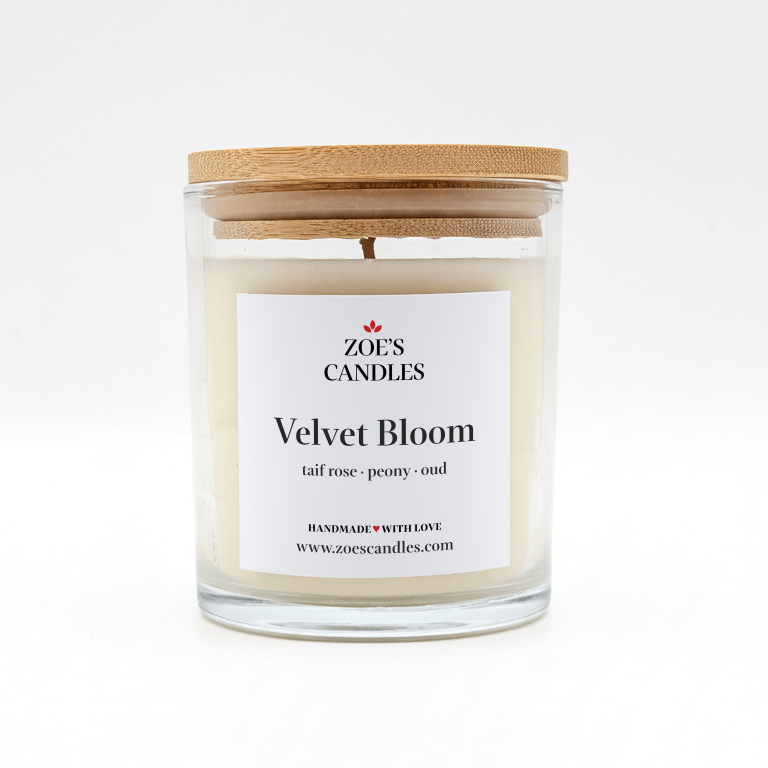 Velvet Bloom scented candle in a clear glass jar with a bamboo lid
